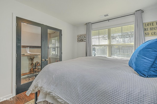 bedroom with hardwood / wood-style flooring