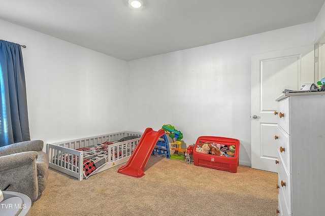 bedroom with carpet and a crib