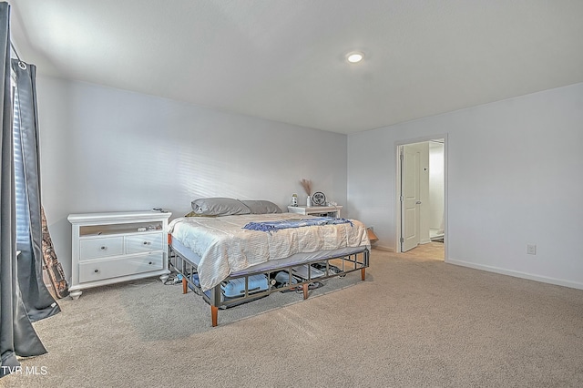 carpeted bedroom featuring ensuite bath