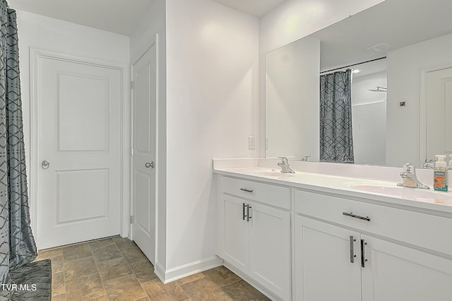 bathroom featuring curtained shower and vanity