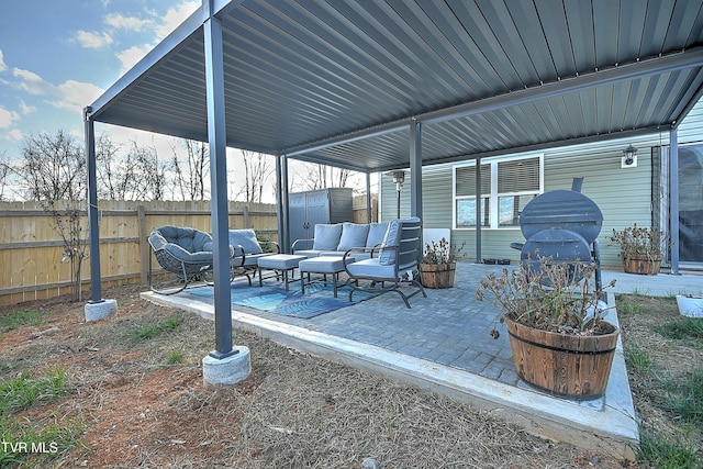 view of patio with outdoor lounge area and a storage shed