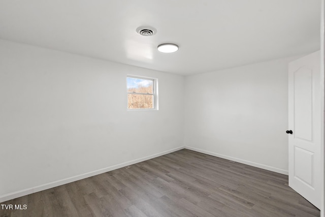 spare room featuring wood-type flooring