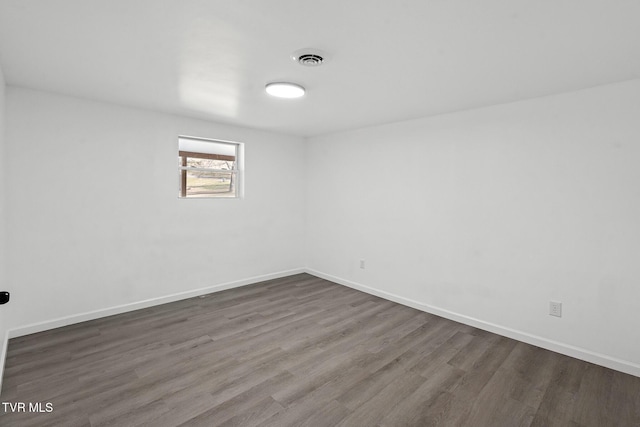 spare room with dark hardwood / wood-style floors