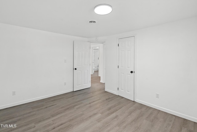 unfurnished room with light hardwood / wood-style floors