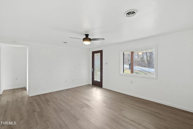 spare room featuring light hardwood / wood-style floors and ceiling fan