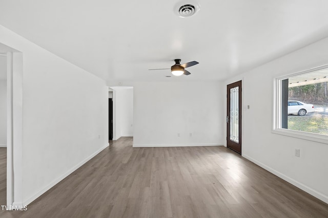 unfurnished living room with ceiling fan and hardwood / wood-style floors