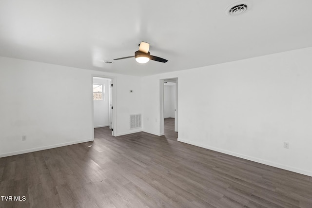 unfurnished room with dark hardwood / wood-style flooring and ceiling fan