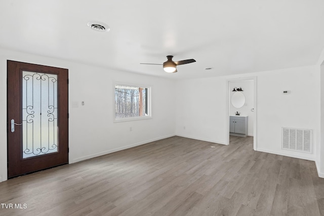 foyer entrance featuring light hardwood / wood-style floors and ceiling fan