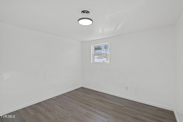 spare room with dark hardwood / wood-style floors