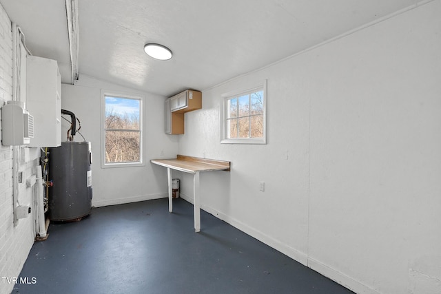 basement featuring electric water heater and a wealth of natural light