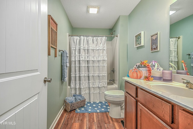 full bathroom featuring shower / bath combo, vanity, a textured ceiling, wood-type flooring, and toilet