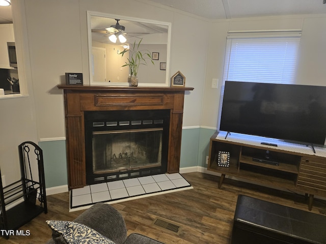 living room featuring dark hardwood / wood-style flooring and ceiling fan