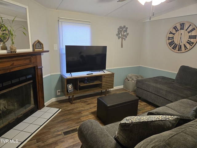 living room featuring ceiling fan and dark wood-type flooring