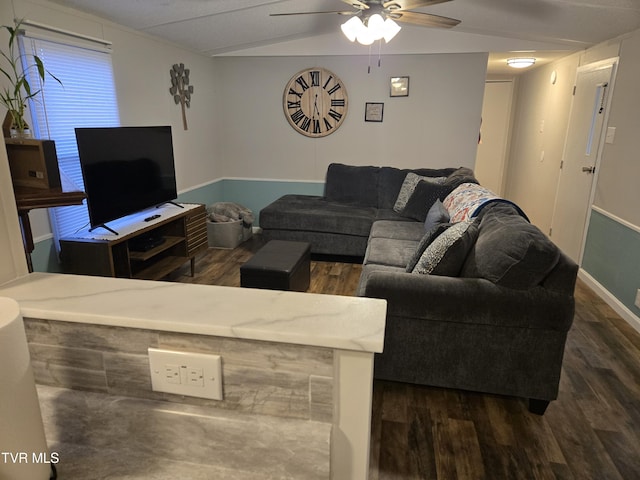 living room with ceiling fan, dark hardwood / wood-style flooring, and lofted ceiling