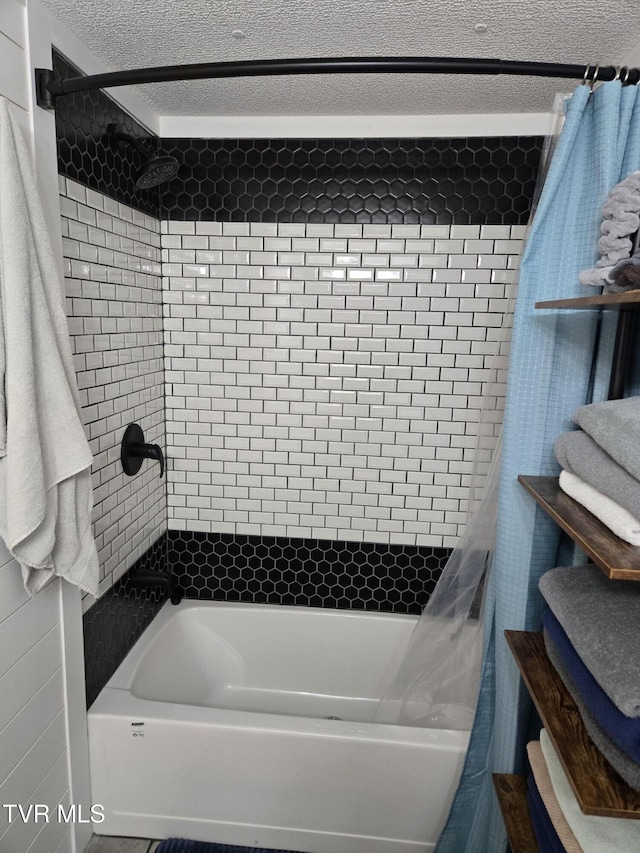 bathroom featuring a textured ceiling and shower / bath combo