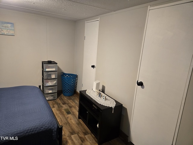 bedroom with dark wood-type flooring