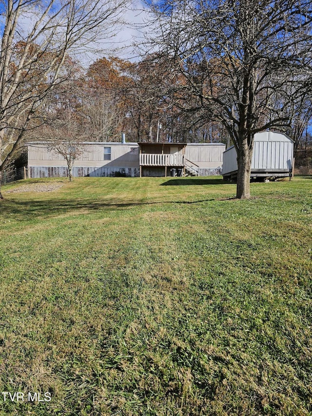 view of yard with a wooden deck