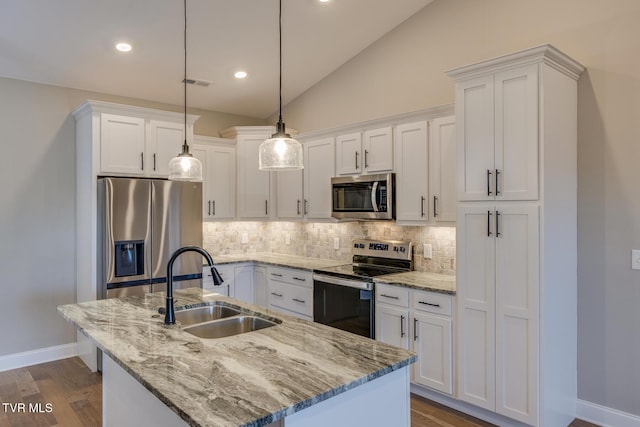 kitchen with white cabinets, decorative light fixtures, sink, and appliances with stainless steel finishes