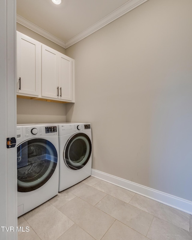 laundry area with crown molding, light tile patterned floors, cabinets, and independent washer and dryer