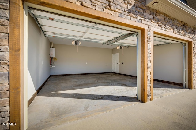 garage with water heater and a garage door opener