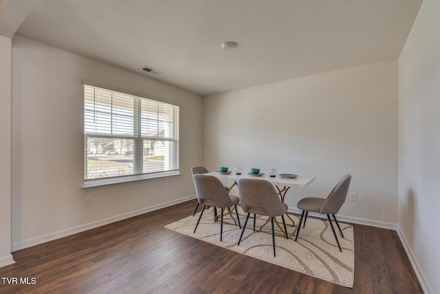 dining room featuring dark hardwood / wood-style flooring