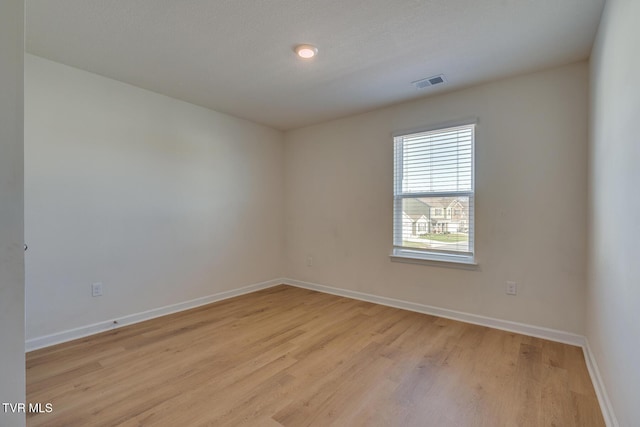 empty room with light hardwood / wood-style flooring