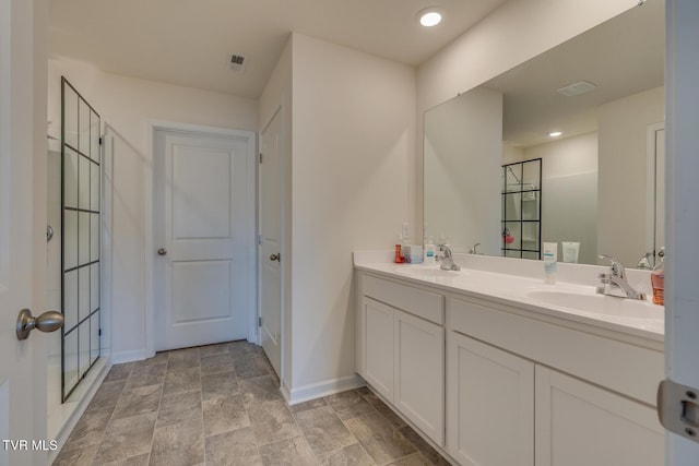 bathroom featuring vanity and an enclosed shower