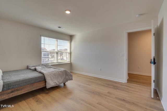 bedroom with light wood-type flooring