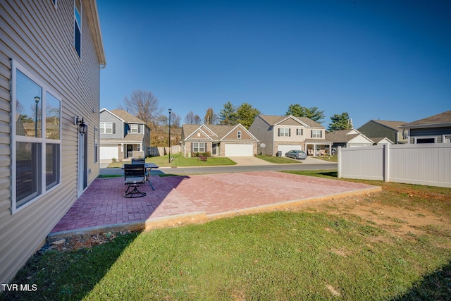 view of yard featuring a patio and a garage