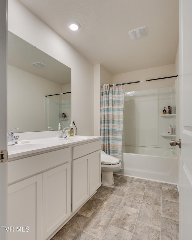 full bathroom featuring vanity, shower / bath combo, and toilet