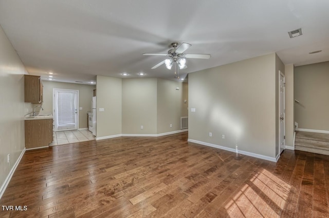 1505 Kensington Pl Unit 1505, Johnson City, TN 37615 - unfurnished living room with light wood-style floors, a ceiling fan, baseboards, recessed lighting, and a sink