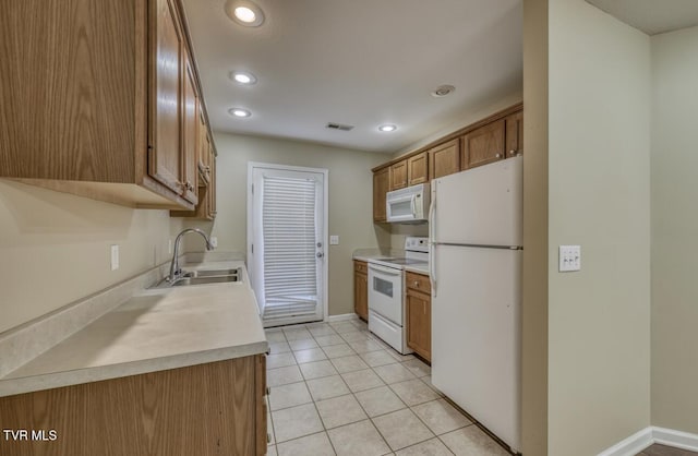1505 Kensington Pl Unit 1505, Johnson City, TN 37615 - kitchen with white appliances, a sink, brown cabinets, recessed lighting, and light countertops