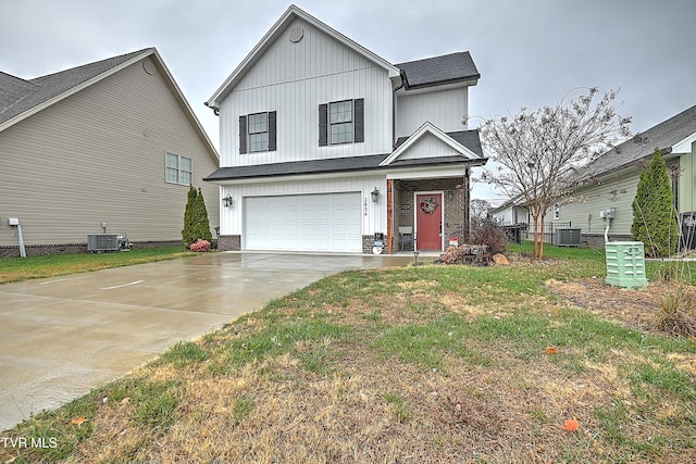 view of front of home featuring central AC, a front lawn, and a garage