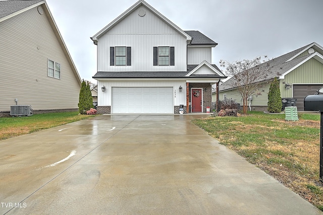 view of front of house featuring central AC, a garage, and a front lawn