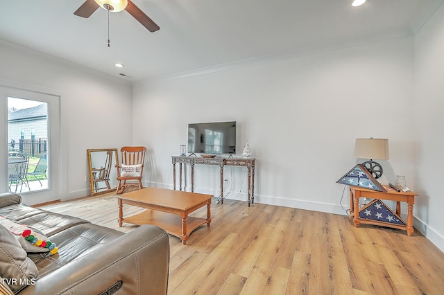 living room with ceiling fan, light hardwood / wood-style flooring, and ornamental molding