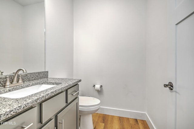 bathroom featuring hardwood / wood-style floors, vanity, and toilet