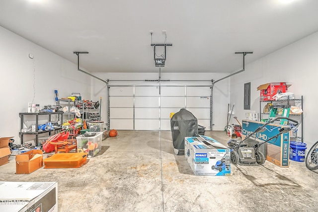 garage with a garage door opener and electric panel