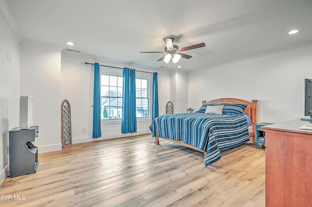 bedroom with ceiling fan, crown molding, and light hardwood / wood-style flooring