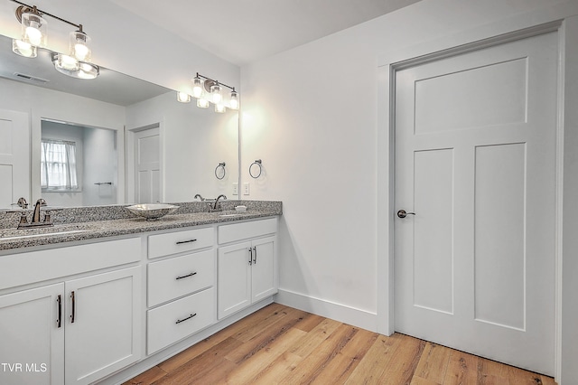 bathroom with hardwood / wood-style floors and vanity