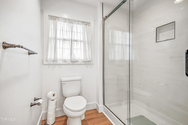 bathroom featuring hardwood / wood-style floors, toilet, and an enclosed shower