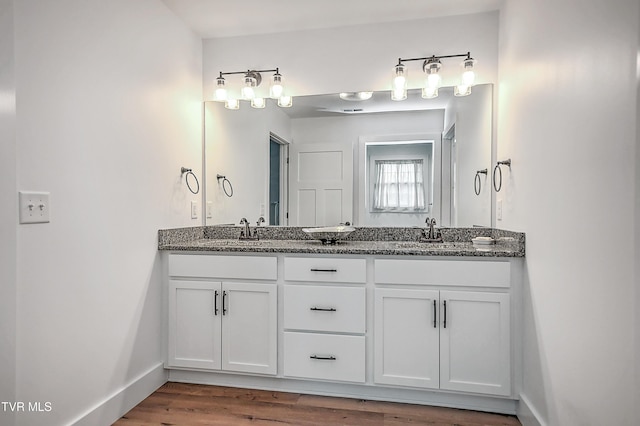 bathroom featuring hardwood / wood-style flooring and vanity