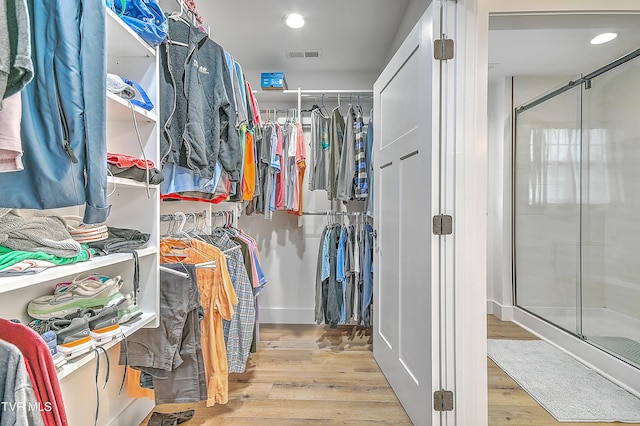 spacious closet with light hardwood / wood-style flooring