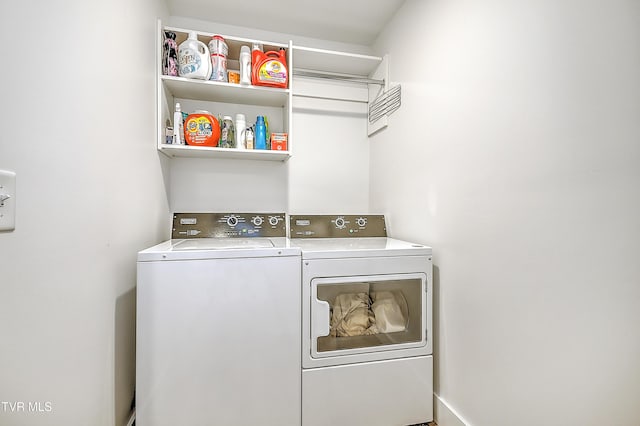 clothes washing area with washer and clothes dryer