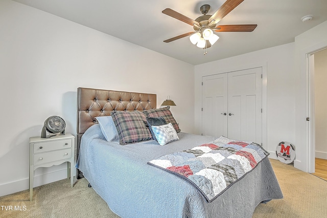 bedroom featuring light carpet, a closet, and ceiling fan