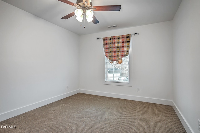 carpeted empty room featuring ceiling fan