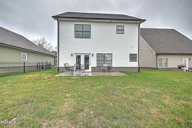 rear view of property with a patio area and a yard