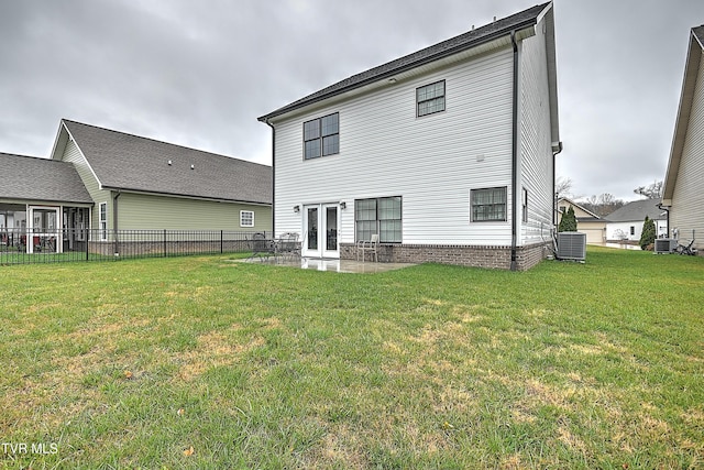 back of property featuring a lawn, a patio area, french doors, and central AC unit