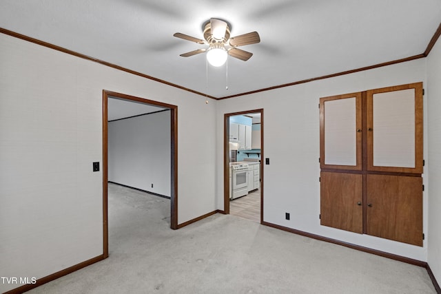 interior space featuring ceiling fan and crown molding