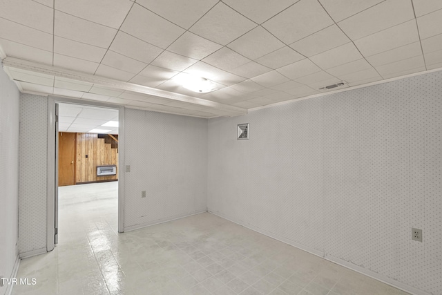 basement featuring wooden walls