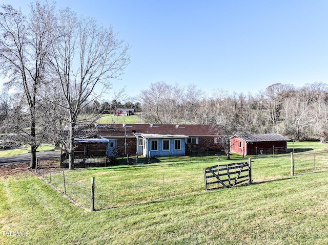 exterior space with an outbuilding, a front lawn, and a rural view